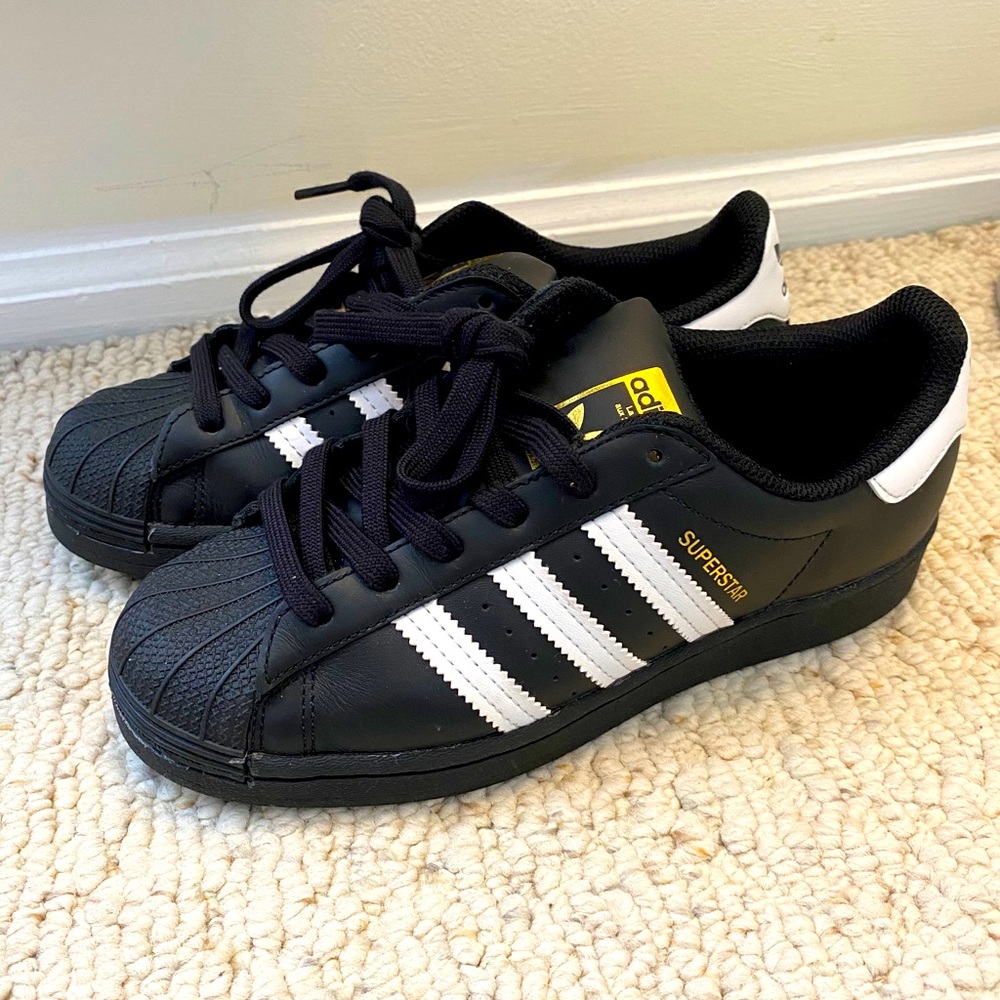 Black Adidas “Superstar” sneakers, white stripes